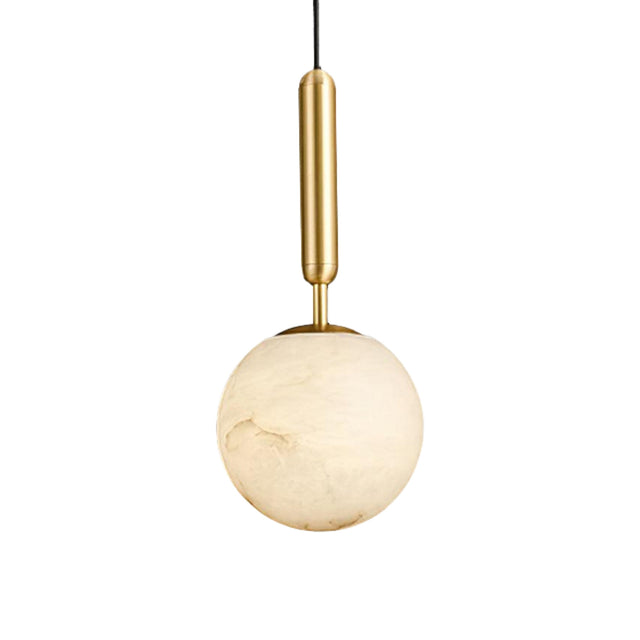 The Lucentis 1 Light Globe Alabaster Single Pendant Light in Soft White & Brass hangs elegantly, adding a modern touch and gentle illumination to any space.
