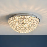 Endon Cordelia 3 light crystal flush bathroom ceiling light in chrome, illuminated on a white ceiling with a dark blue wall below.