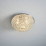 Endon Cordelia 3 light crystal flush bathroom ceiling light in chrome, domed faceted crystal shade illuminated on a light grey ceiling.
