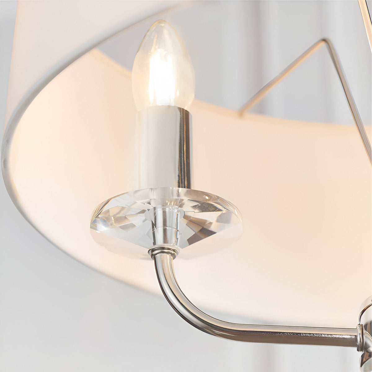 Close-up of Endon Castdon 3 Light Pendant showing a nickel arm, K9 crystal bobeche, E14 candle bulb, and vintage white faux silk shade.