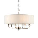 Castdon 6 Light Pendant in nickel with a large white drum shade, six curved arms, crystal accents and hanging chain, shown on a plain white background.