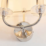 Close-up of the Castdon 2 Light Wall Light in nickel, showing curved twin arms with cut-crystal accents and E14 lamp holders.
