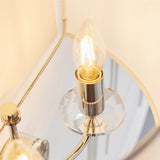 Close-up of the Castdon 2 Light Wall Light in nickel, showing a candle-style bulb on a plated arm with a faceted crystal base, beneath a white shade.