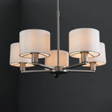 Bexley 5 Light Pendant in matt nickel, five curved arms with white faux silk drum shades, shown against a dark background.