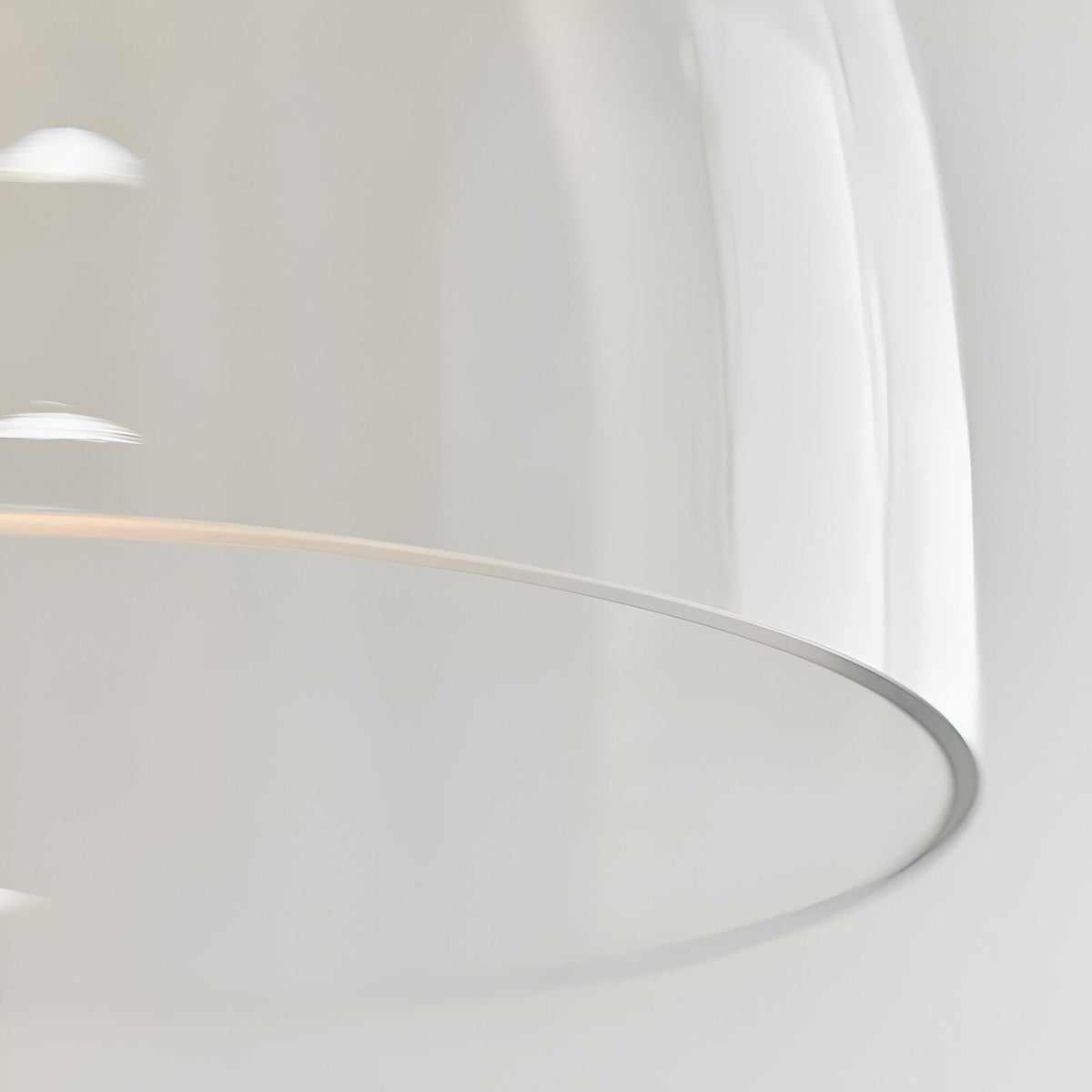 Close-up of the Endon Brackmere pendant light showing the clear glass shade's curved profile and polished chrome trim around the rim.