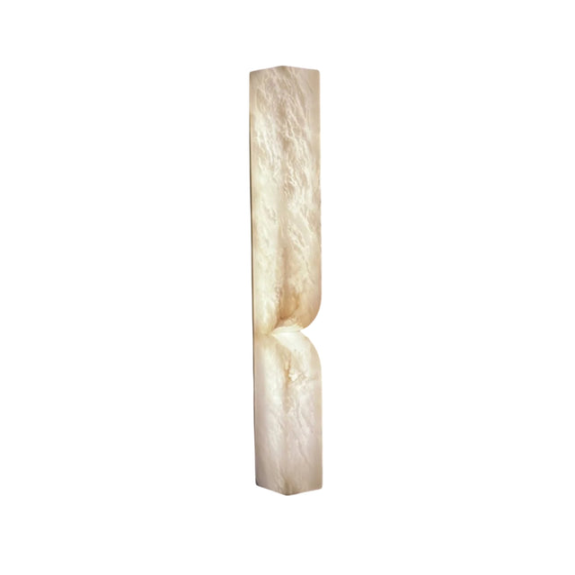 The Vera LED Large Silhouette Alabaster Wall Light – Soft White is a tall, narrow rectangular fixture with a smooth, subtly textured cream surface and a curved indentation near the lower middle, displayed against a white background.