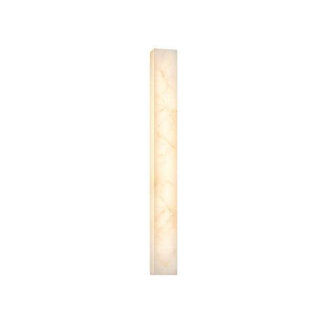 The Aureline LED Medium Sculpted Column Alabaster Wall Light emits a soft white glow. Its tall, narrow form and marble-like Spanish alabaster pattern stand out against a plain white background.