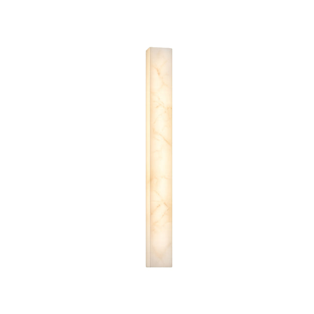 The Aureline LED Medium Sculpted Column Alabaster Wall Light emits a soft white glow. Its tall, narrow form and marble-like Spanish alabaster pattern stand out against a plain white background.