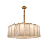 The Lunaro 16 Light Circular Panel Alabaster Chandelier features a modern round, layered soft white shade with a brushed brass finish, suspended by a twisted rod from the ceiling.