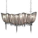 Niori Mireya 8 light linear chandelier in nickel, with draped metal chain veil and tapered strands, suspended from two decorative square-link chains.