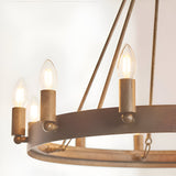 Close-up of the Bevgrove 12 Light Pendant, an aged metal ring fitting with candle-style E14 bulbs on brass-toned holders against a plain white background.