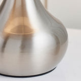 Close-up of the Endon Chartbury LED table lamp's satin nickel plated metal base, showing its curved teardrop shape against a light background.