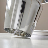 Danefield Table Lamp in chrome, close-up of the mirrored glass base and cream fabric shade edge on a light surface.