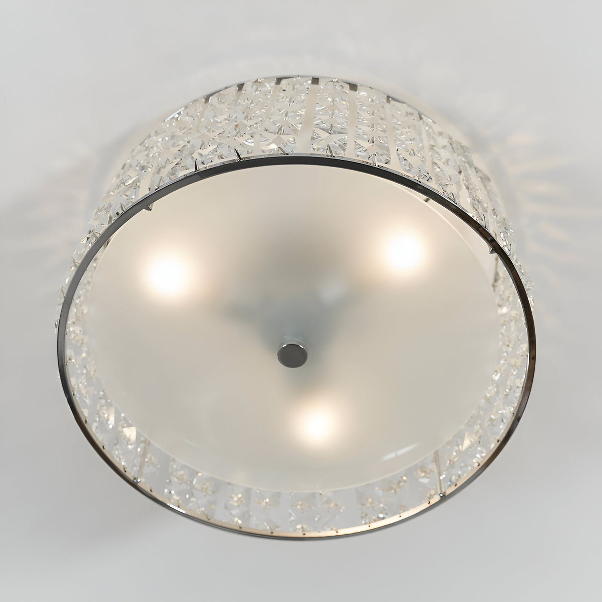 Underside view of the Endon Ophelia 3 light flush bathroom ceiling light in chrome, showing three illuminated G9 lamps behind a frosted glass diffuser.
