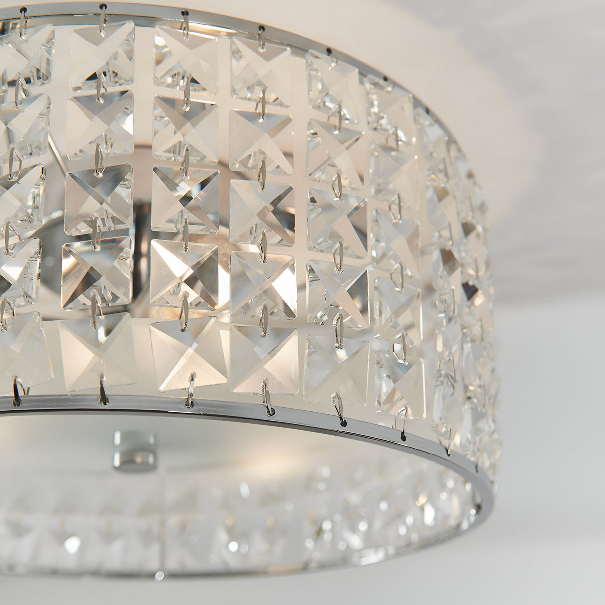 Close-up of Endon Ophelia 3 light flush bathroom ceiling light showing chrome frame with square crystal and glass detailing around a drum shade.