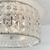 Close-up of Endon Ophelia 3 light flush bathroom ceiling light showing chrome frame with square crystal and glass detailing around a drum shade.