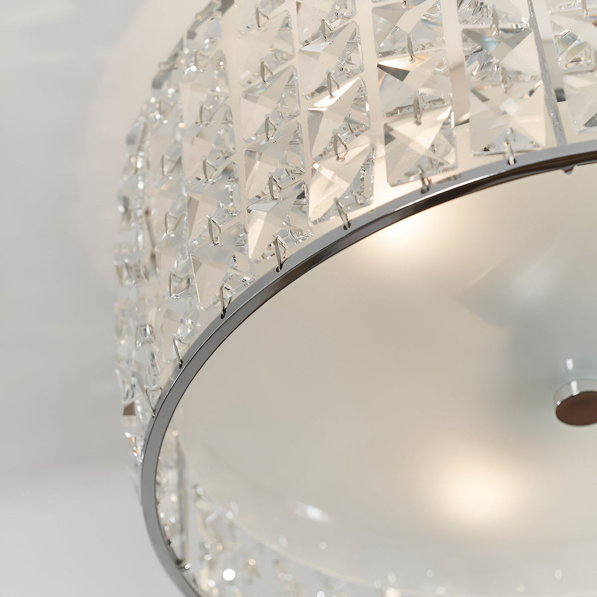 Close-up of Endon Ophelia flush bathroom ceiling light showing chrome trim, crystal-set drum shade and frosted glass diffuser with illuminated G9 lamp.