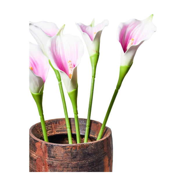 Libra Interiors Calla Lily faux stems with cream petals shading to lilac and pink centres, green stems arranged in a rustic wooden pot.