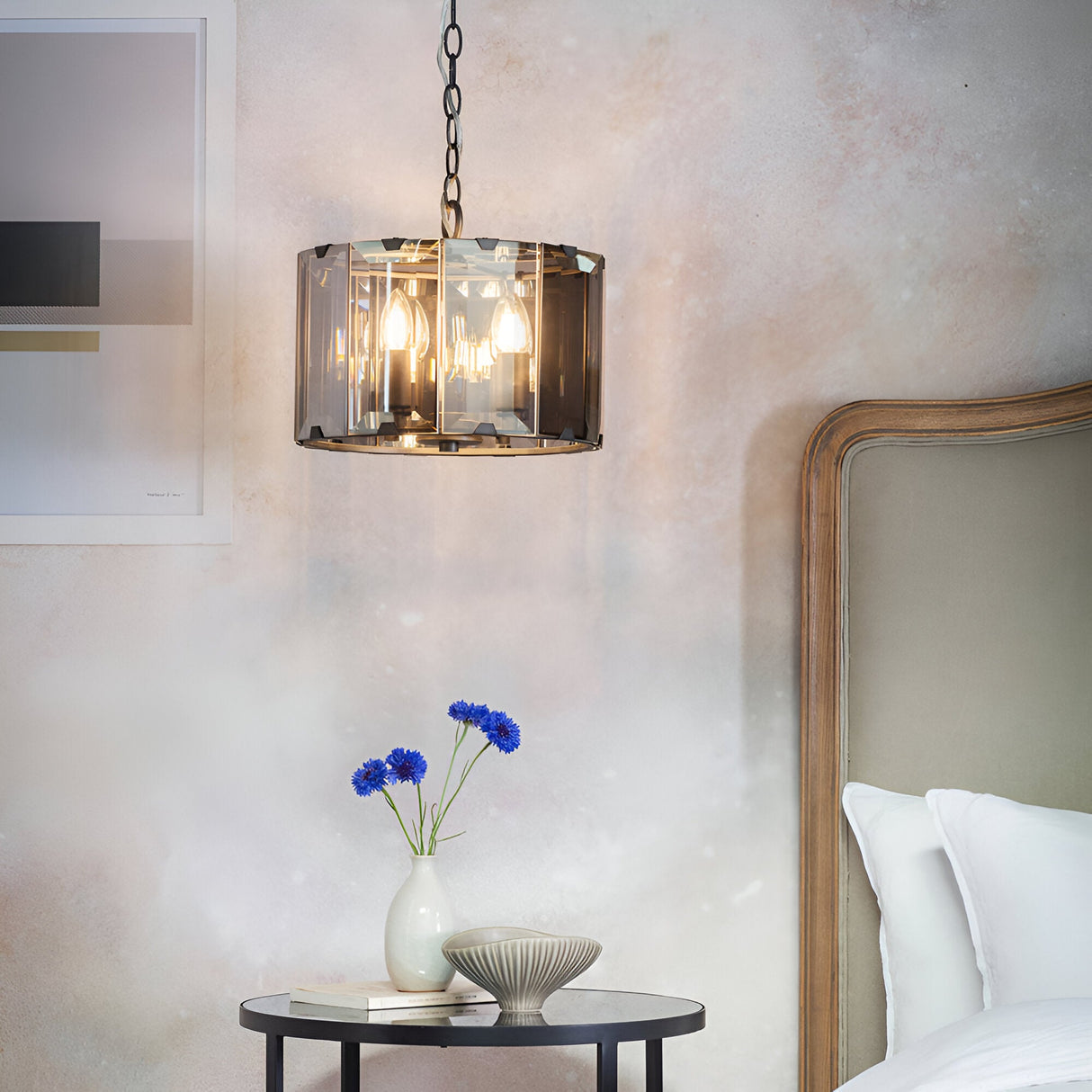 Bevshaw 4 Light Pendant in slate grey with bevelled smoke glass panels, hanging on a chain above a bedside table in a bedroom setting.