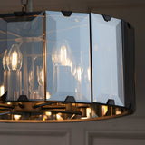 Close-up of Endon Bevshaw 8 light pendant showing bevelled smoke glass panels on a slate grey frame with lit E14 filament candle bulbs inside.