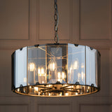Endon Bevshaw 8 light pendant with bevelled smoke glass panels and slate grey frame, suspended from a chain against a panelled wall.