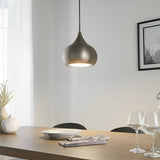Ashleigh Pendant in matt nickel, a single teardrop-shaped LED ceiling light with white diffuser, shown above a wooden dining table.