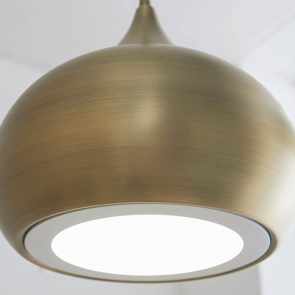 Close-up of the Endon Ashleigh pendant light showing its domed matt antique brass shade and white LED diffuser against a plain background.