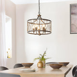 Hulton 5 Light Pendant in bronze and black open lattice metalwork with five exposed bulbs, hung above a dining table on a black chain.