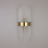 The Oriana 2 Light Crystal Wall Light - Gold showcases vertical glass rods and a central gold band, offering elegant luxury lighting that enhances any light-colored wall.