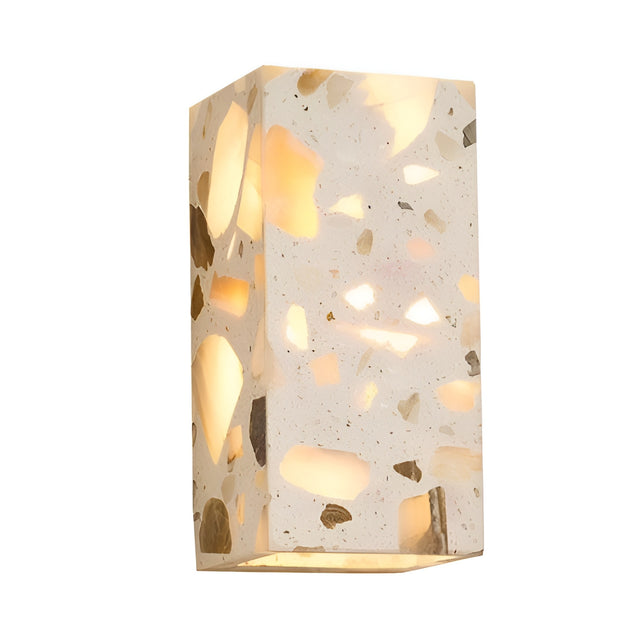 The Terrano 1 Light Rectangular Travertine Wall Light in light beige features a modern design and emits a warm, inviting glow from within its travertine surface, creating an elegant ambiance on any wall.