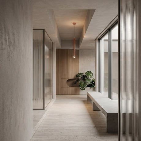 A minimalist hallway with light wood floors, a concrete bench, frosted glass panels, a wooden accent wall, a potted plant, and a Micro LED Pendant Light - Copper hanging from the ceiling. Natural light streams in through large windows.