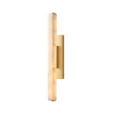 The Selvara LED Large Alabaster Wall Light in brushed brass features a vertical, elongated soft white shade and a gold backplate, casting a gentle, warm glow and bringing modern elegance to any plain white wall.
