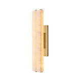 The Selvara LED Medium Alabaster Double Wall Light features a brushed brass base and soft white, vertically elongated frosted glass shade, emitting a warm, gentle glow against a white background.