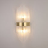 The Oriana 2 Light Crystal Wall Light - Gold features a central gold band and vertical glass rods, casting warm light up and down for a luxurious effect on any plain light wall.