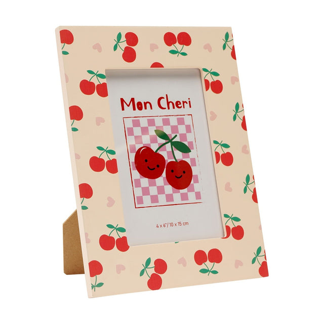 Wooden rectangular photo frame with stand in peach, printed with red cherries, green stalks, and pink hearts, holding a "Mon Cheri" sample photo on a plain white background.
