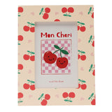 Rectangular wooden photo frame in peach with an all-over print of red cherries, green stalks and pink hearts, holding a "Mon Cheri" cherry graphic insert, shown on a white background.