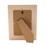 Back view of the Cherries and Hearts Wooden Photo Frame in peach, showing the fold-out stand, hanging hooks, and fibreboard backing on a white background.