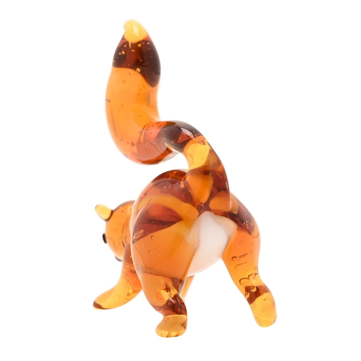 Miniature glass squirrel figurine in warm orange tones with a white underside and tall curled tail, rear view on a plain white background.