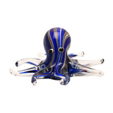 Swirl Octopus Glass Figurine with a deep blue, brown and white swirled head, black and white eyes, and spread tentacles fading to clear glass tips, shown on a plain white background.