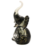 Trumpet Elephant Streaked Glass Figurine in black and grey, sitting upright with trunk raised and clear glass tip, spread ears, on a plain white background.