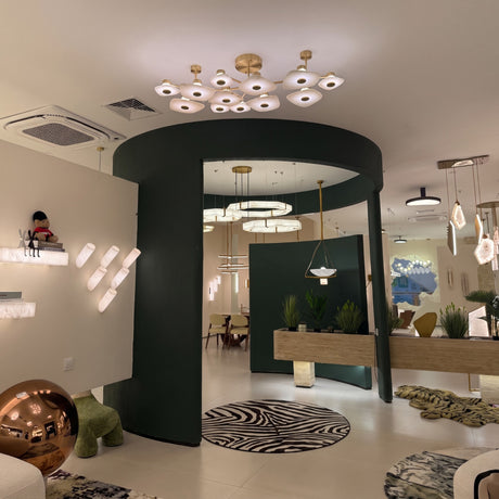 Calyra Large LED Alabaster Semi-Flush Ceiling Light with twelve brass-framed alabaster panels arranged at varying heights, shown installed above a curved green archway.