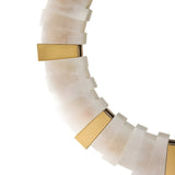 Close-up of the Lumessa LED Alabaster Mirror Light in Brushed Brass & Soft White, showcasing sculptural alternating white and gold metallic segments in a repeating pattern against a white background.