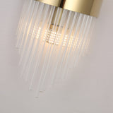 Close-up of the Oriana 2 Light Crystal Wall Light - Gold, featuring a gold metallic base and multiple clear glass rods, illuminated by LED lights that cast a warm glow on a light-colored wall.