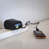 Mercury SMDC400UK switch-mode 12V power supply by AVSL plugged into a white extension socket, powering a small orange and black media player.