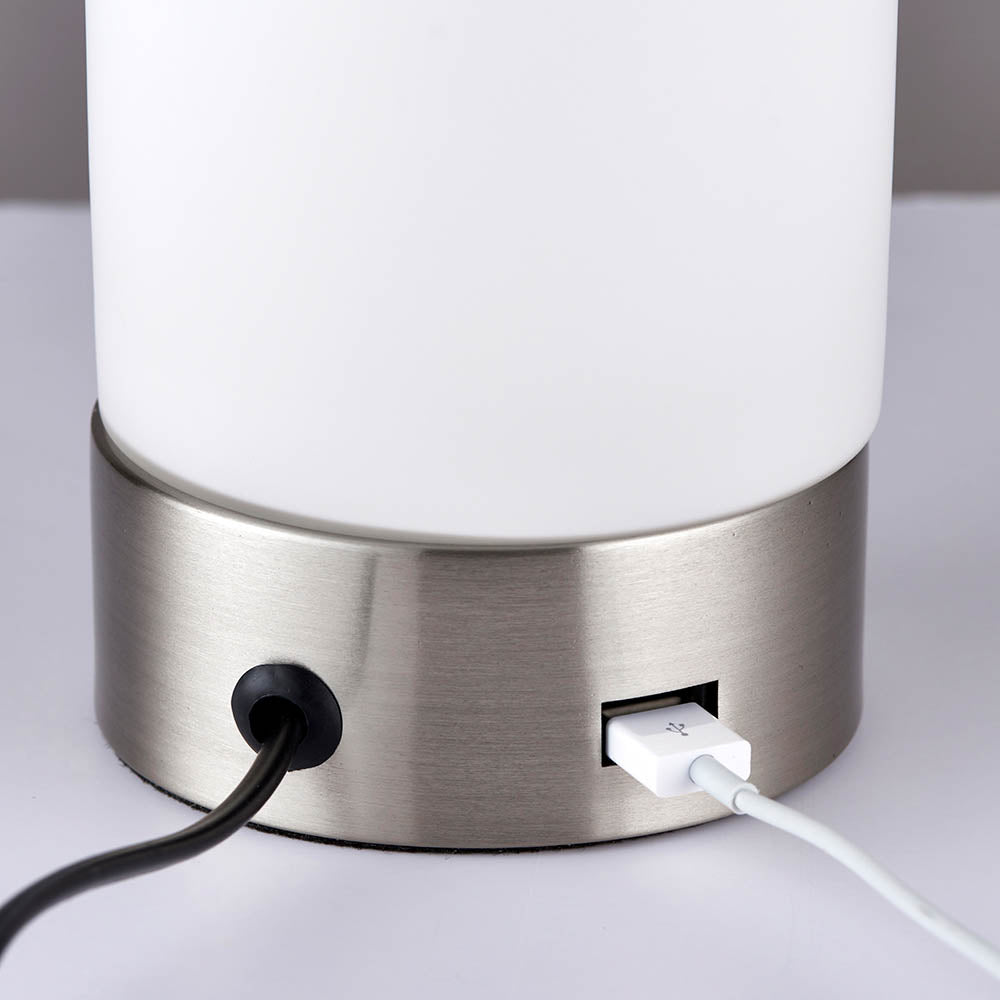 Close-up of the Endon Bracewell table lamp base in brushed nickel, showing the black flex outlet and integrated USB charging port.