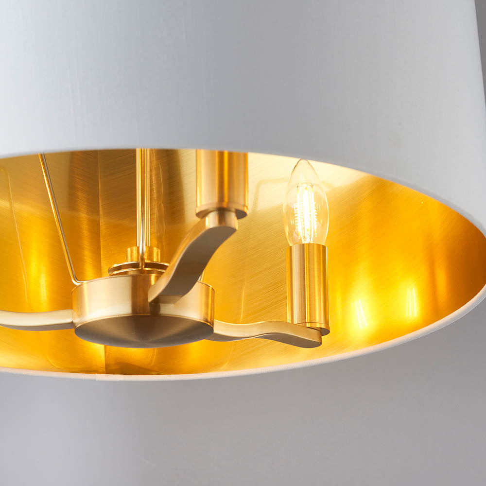 Close-up inside the Endon Brendale 3 Light Pendant, showing the brushed gold metalwork, three E14 lamp holders and metallic gold-lined white shade.