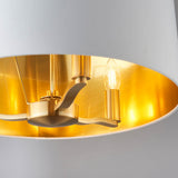 Close-up inside the Endon Brendale 3 Light Pendant, showing the brushed gold metalwork, three E14 lamp holders and metallic gold-lined white shade.