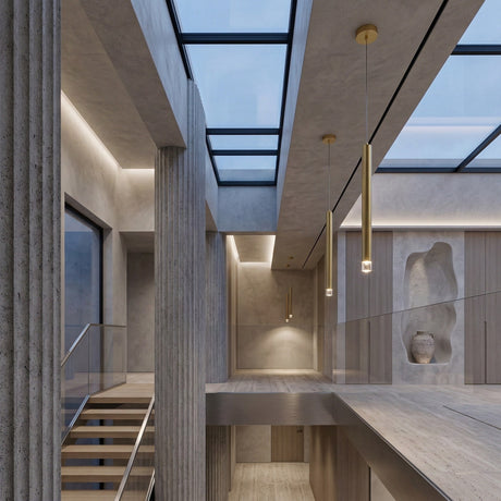 Modern interior with concrete columns, wooden floors, glass railings, and a large skylight ceiling. Minimalist décor includes a sculptural wall niche with a vase and sleek Micro LED Pendant Light - Gold for contemporary lighting.