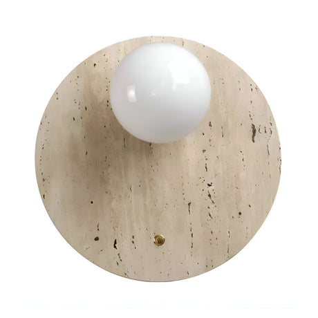 The Serano 1 Light Disc Travertine Wall Light in light beige features a round, smooth travertine surface with a central white glass globe and a small brass accent, offering elegant natural stone lighting.
