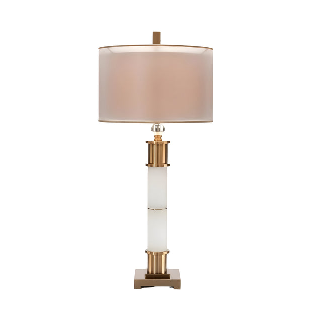 The Alverin 1 Light Segmented Alabaster Table Lamp in brass & soft white features a cylindrical beige shade, gold and white column base, and a square gold stand, displayed against a white background.